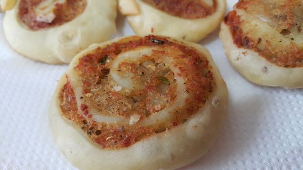 Closeup of delicious home made pinwheel puff pastries food item placed over white background