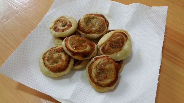Closeup of delicious home made pinwheel puff pastries food item placed over white background
