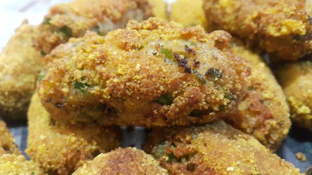 Closeup perspective view of home made spicy and delicious croquettes served with tea or other dishes during parties as fast food.