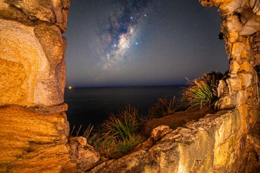 Views to the night sky from inside the cave set into the cliffs of Sydney. Milky way galaxy shining as brightly as possible