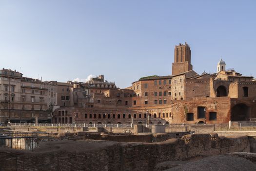 Rome, Italy - June 27, 2010: General view of the galleries, arches and buildings arranged in a semicircle, of Trajan's Market, in Trajan's forum, with the Militia Tower in the background, Rome.