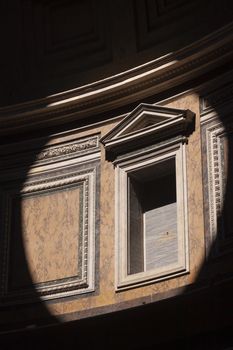 Rome, Italy - June 28, 2010: Detail of the light coming through the dome of the Pantheon in Rome and the Basilica of Santa Maria Rotonda.