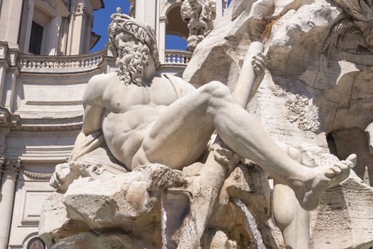 Rome, Italy - June 28, 2010: Detail of the statue depicting the god of the river Ganges at the Fountain of the Four Rivers, Piazza Navona, Rome.