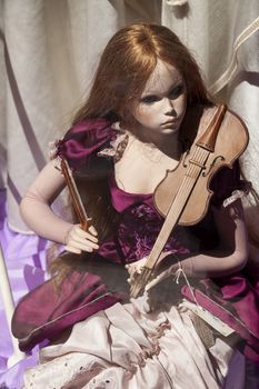 Rome, Italy - June 28, 2010: Sinister, creepy, beauty and delicate porcelain doll, in a shop window, Rome.