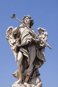 Rome, Italy - June 28, 2010: One of the famous statues of angels, the one with the sponge, on the Sant'Angelo bridge near the Castle of the same name.