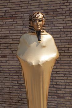 Rome, Italy - June 28, 2010: A person works, very still, as a mime, disguised as an Egyptian pharaoh, near the Castel Sant'Angelo in Rome.