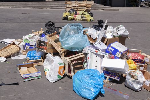 Rome, Italy - June 28, 2010: Boxes, bags and various rubbish, thrown away and abandoned next to one of the street markets in Rome.