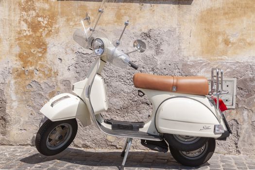 Rome, Italy - June 28, 2010: A retro, vintage motorcycle, a symbol of contemporary urban culture and lifestyle in Rome, is parked in a central street.