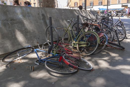 Rome, Italy - June 28, 2010: A lot of bicycles, old, some broken, remain abandoned and rusting in a street in Rome.