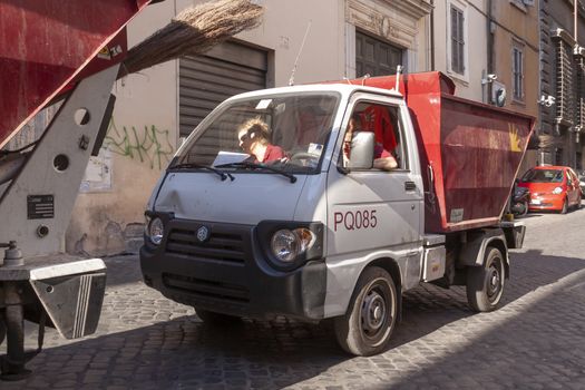 Rome, Italy - June 29, 2010: Two women drives, one of the trucks of Rome's public garbage collection service.