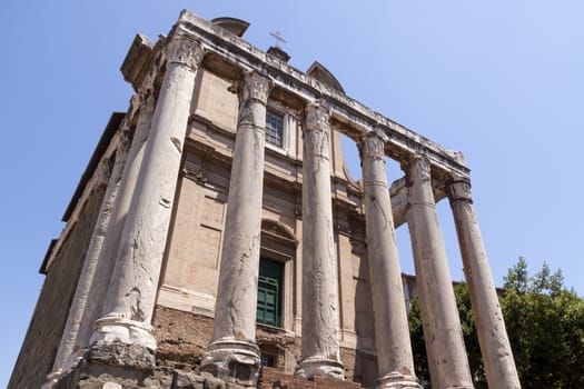 Rome, Italy - June 29, 2010: Remnants of the temple of Antonino and Faustina, and the church of San Lorenzo in Miranda, located inside, in the center of the Roman Forum.