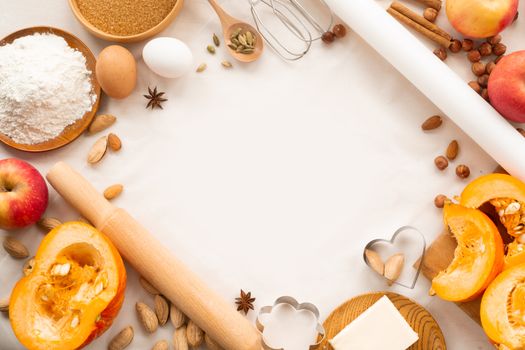Autumn baking background border frame design with copy space for text. Cooking ingredients pumpkin, apples, wheat, honey butter flour nuts, toning, bright orange colors