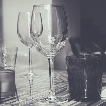 Crystal glasses on decorated glass table.