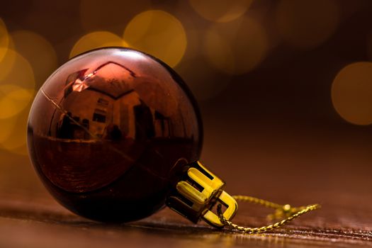 Colorful Christmas ball isolated on blurred and shiny background of lights. Christmas baubles isolated.