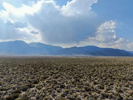 Aerial view of dusty dry desert land and mountain on the background Lee Vining Mono County, California, USA