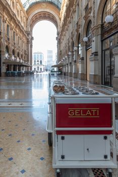 Ice cream cart in a historic gallery in the city of Milan, street photography in Italy