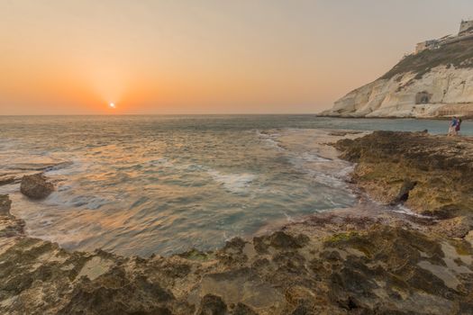 Rosh HaNikra, Israel - September 07, 2020: View of the sunset with the coast and cliffs of Rosh HaNikra, with visitors, Northern Israel