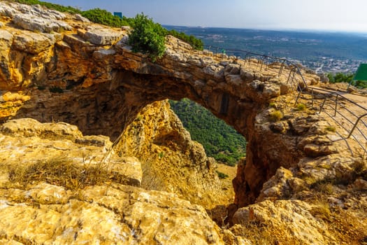 View of the Keshet Cave, a limestone archway spanning the remains of a shallow cave, in Adamit Park, Western Galilee, Northern Israel