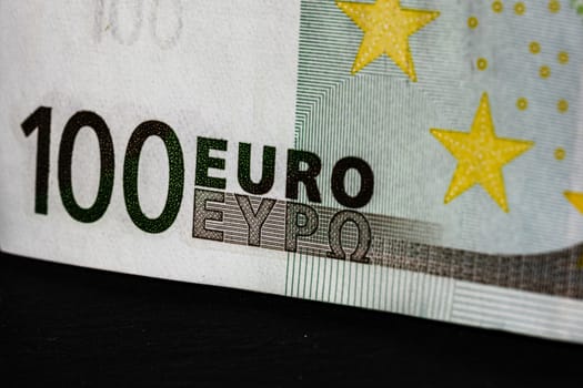Selective focus on detail of euro banknotes. Close up macro detail of money banknotes, 100 euro isolated. World money concept, inflation and economy concept