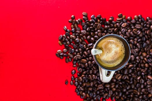 Cup of coffee, roasted coffee beans on red background, top view, copy space for text, coffee concept, close up coffee photo
