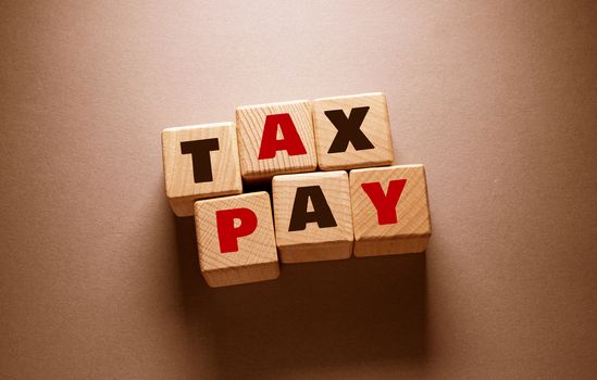 Tax pay Word Written on Wooden Cubes