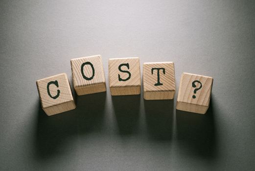 Cost Word Written on Wooden Cubes