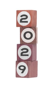 Four isolated hardwood toy blocks on white, saying 2029