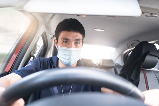 Young Asian man wearing surgical mask driving car so panic shocked during driving at high speed To travel during the outbreak  coronavirus covid-19