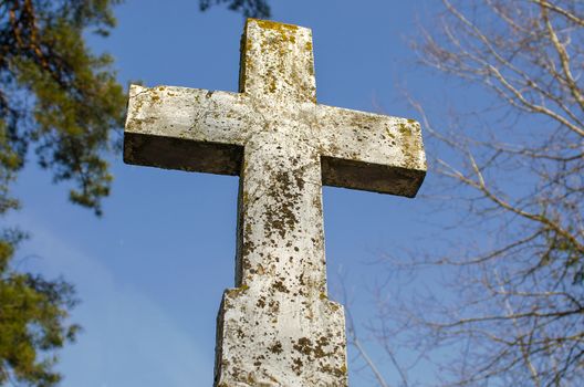 Large crucifix In the graveyard. Concept of Christian belief, being at the crossroads, making a decision. Christian, Easter or halloween background