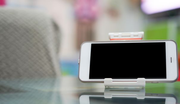 mockup of screen of smartphone on docking on table