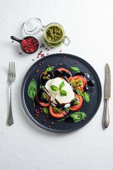 italian caprese salad with cherry kumato tomatoes with black pepper. Close up. top view vertical spacr for text.