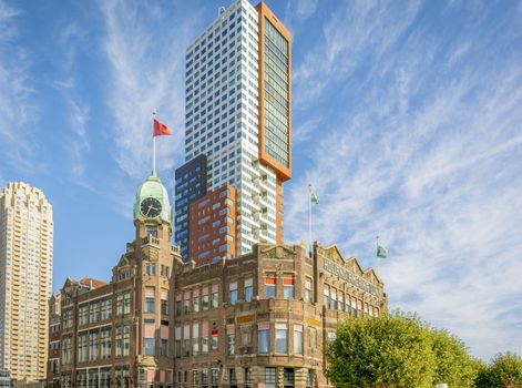 Rotterdam, Wilhelminapier, Netherlands, September 2019: View on the famous Hotel New York with Montevideo tower rising up in the background.