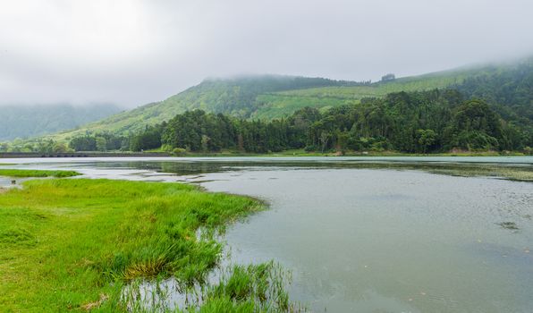 View of the Lake of Sete Cidades in the fog, a volcanic crater lake on Sao Miguel island, Azores, Portugal