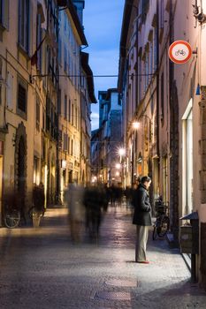 Lucca, Italy - March 6th 2008: A woman looks in a shop window in Via Filungo, Lucca, Tuscany, Italy