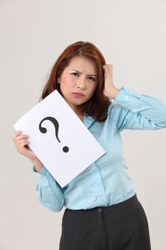 woman holding a paper printed a big question mark