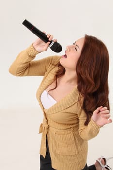 Woman singing, holding wireless microphone