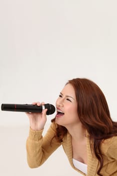 Woman singing, holding wireless microphone