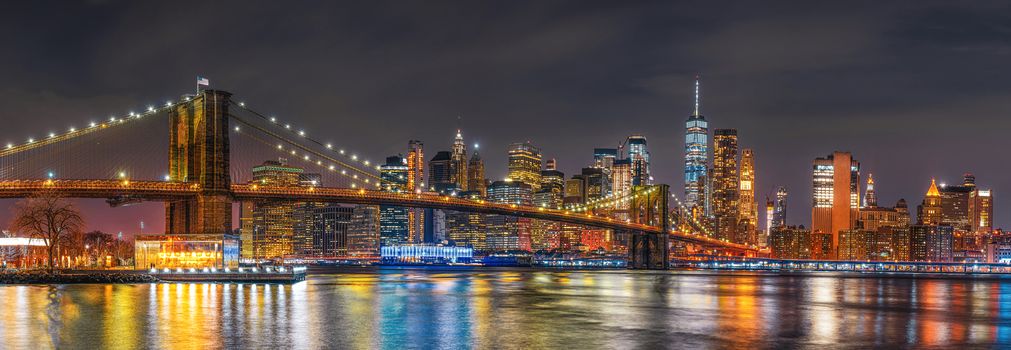 Panorama scene of New york Cityscape with Brooklyn Bridge over the east river at the twilight time, USA downtown skyline, Architecture and building with tourist concept