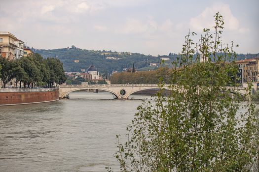 Adige river landscape view in Verona in Italy with a bridge