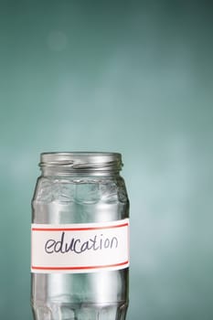 empty glass jar labelled with text education