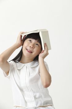 female student  cover her head with book