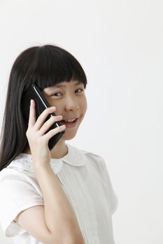 chinese girl talking with cellphone looking at camera