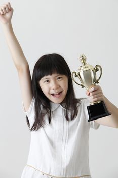 chinese girl holding trophy with raising her arm