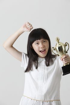 chinese girl holding trophy with raising her arm