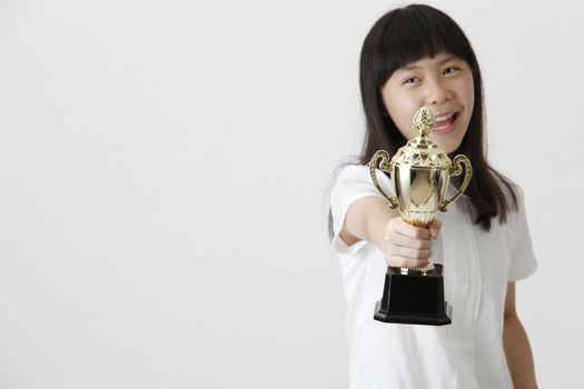 chinese girl holding trophy and the focus on trophy