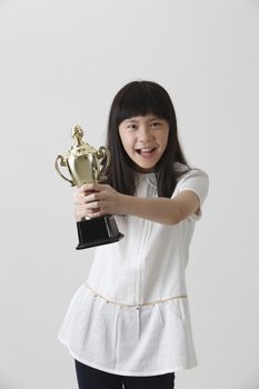 chinese girl holding trophy with both hands
