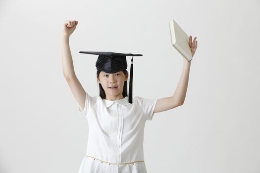 girl with the mortar board holding book