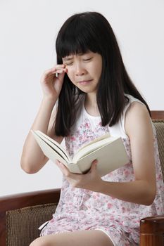 chinese girl reading a sad story book