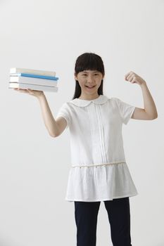 chinese girl showing stack of books 