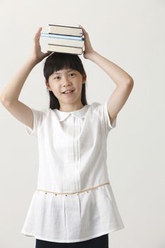 chinese girl balancing with books